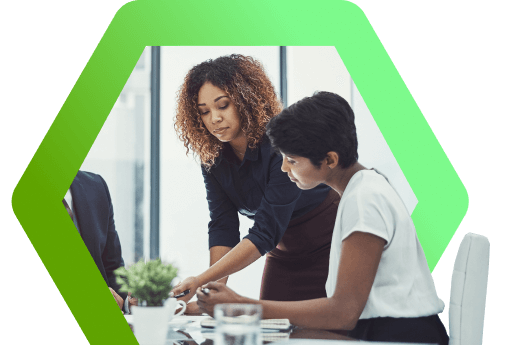 Two professionals collaborating at a workstation, representing Beeline's sales operations team